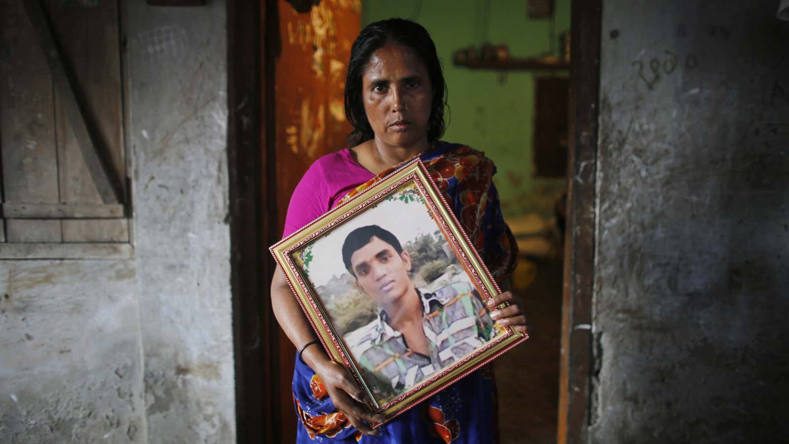 Fatema holds a picture of her son Nurul Karim, who died when  the Rana Plaza factory collapsed in 2013.