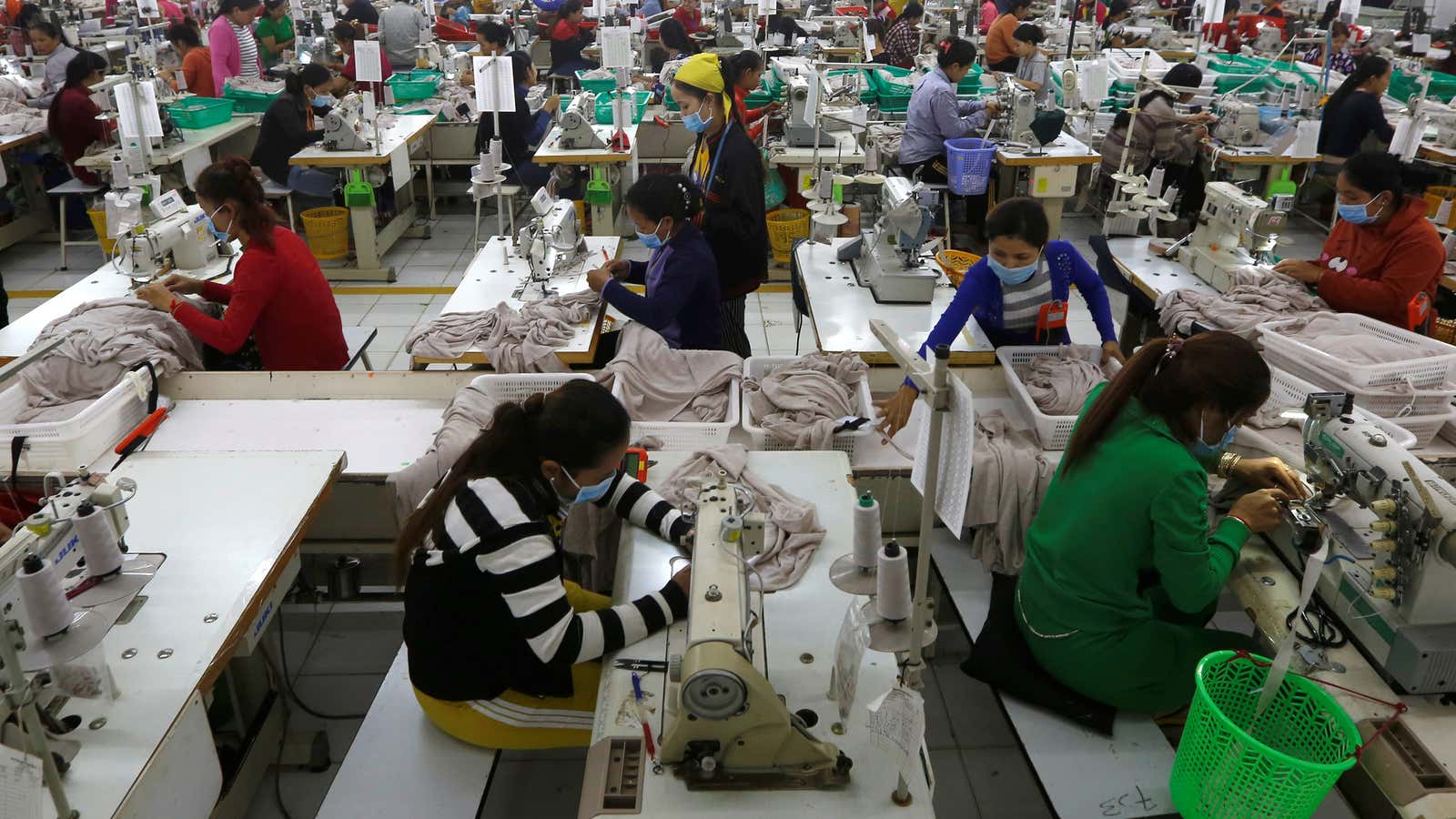 Factories like this garment maker in Cambodia are at risk of closing as raw materials from China run out.