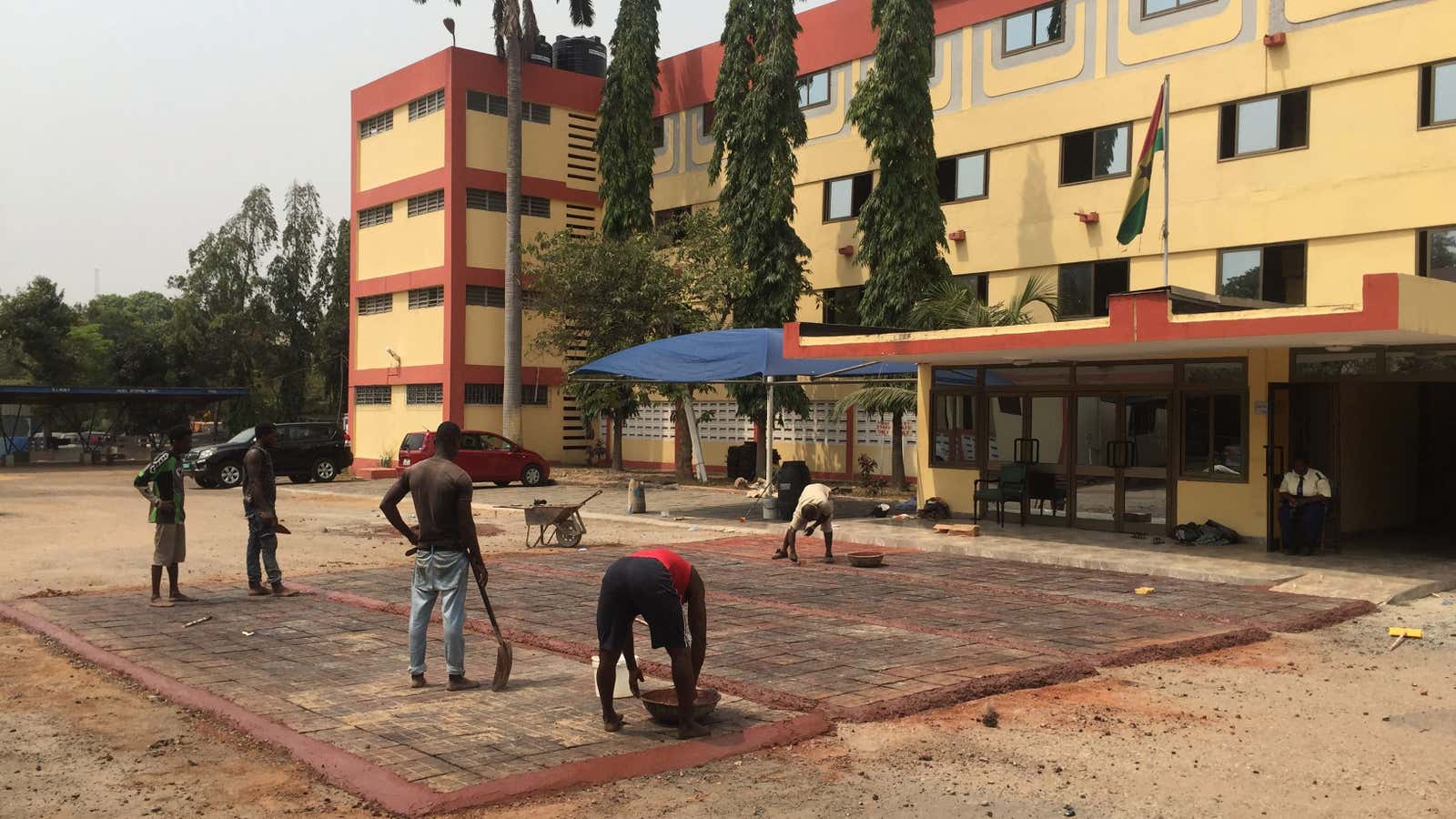 Laying the recycled plastic-infused blocks in Ghana