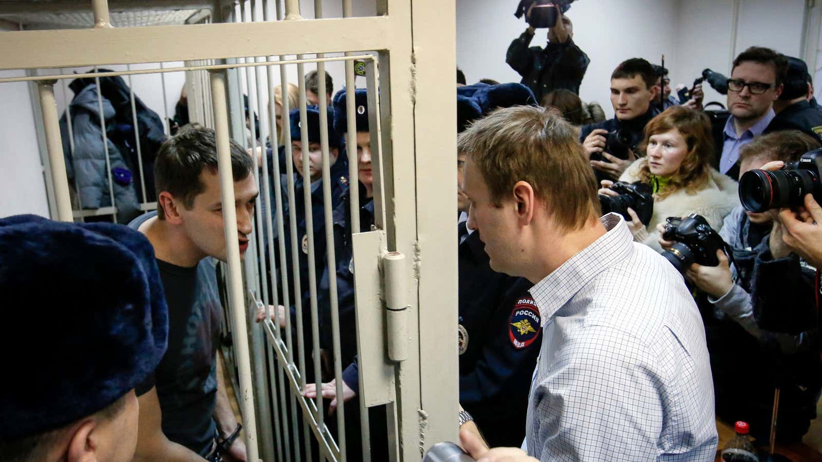 Russian political activist Alexei Navalny talks to his brother Oleg, left, after he was sentenced to more than three years in jail.