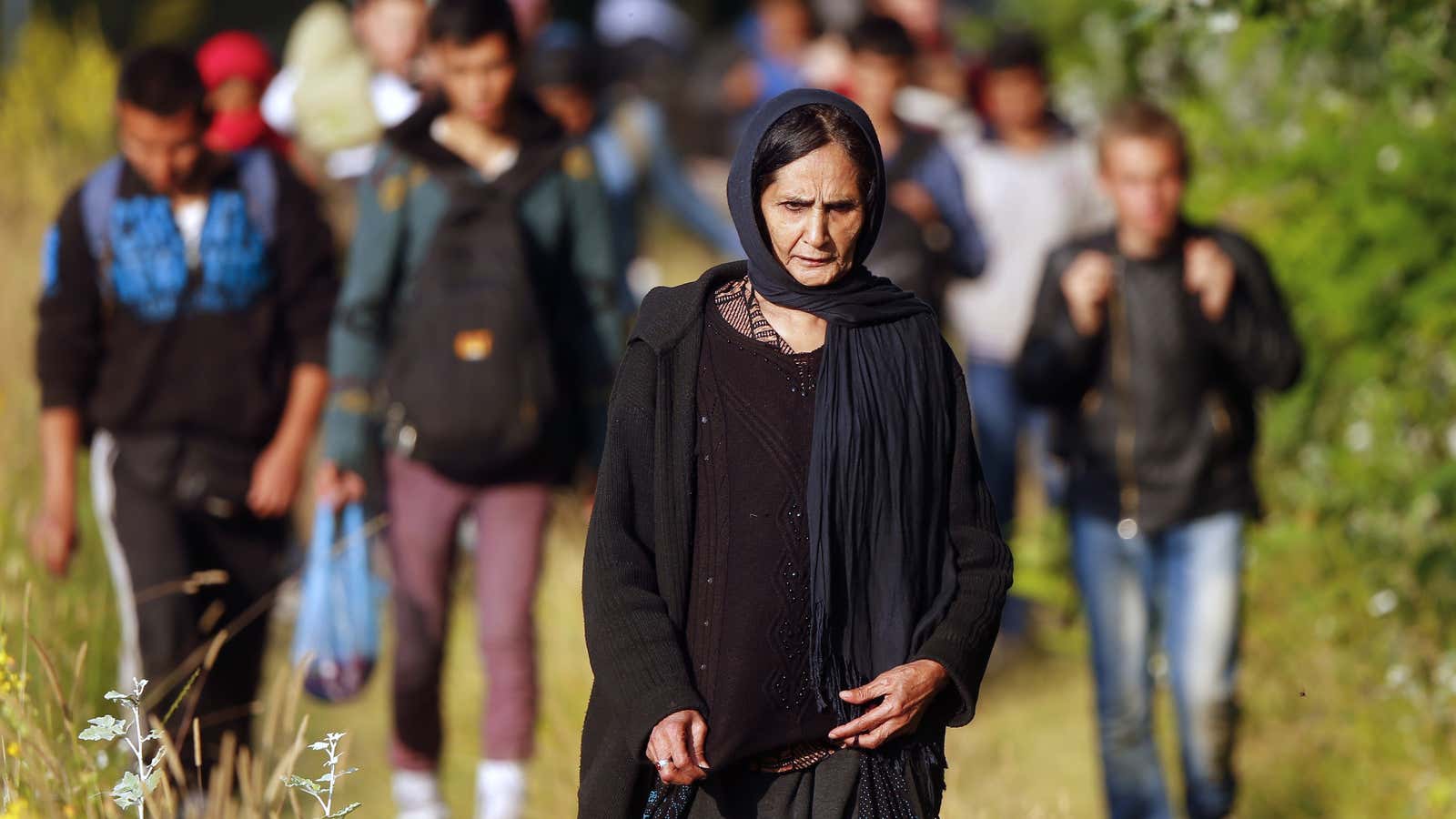 Refugees from Afghanistan walk after crossing the border from Serbia into Hungary.