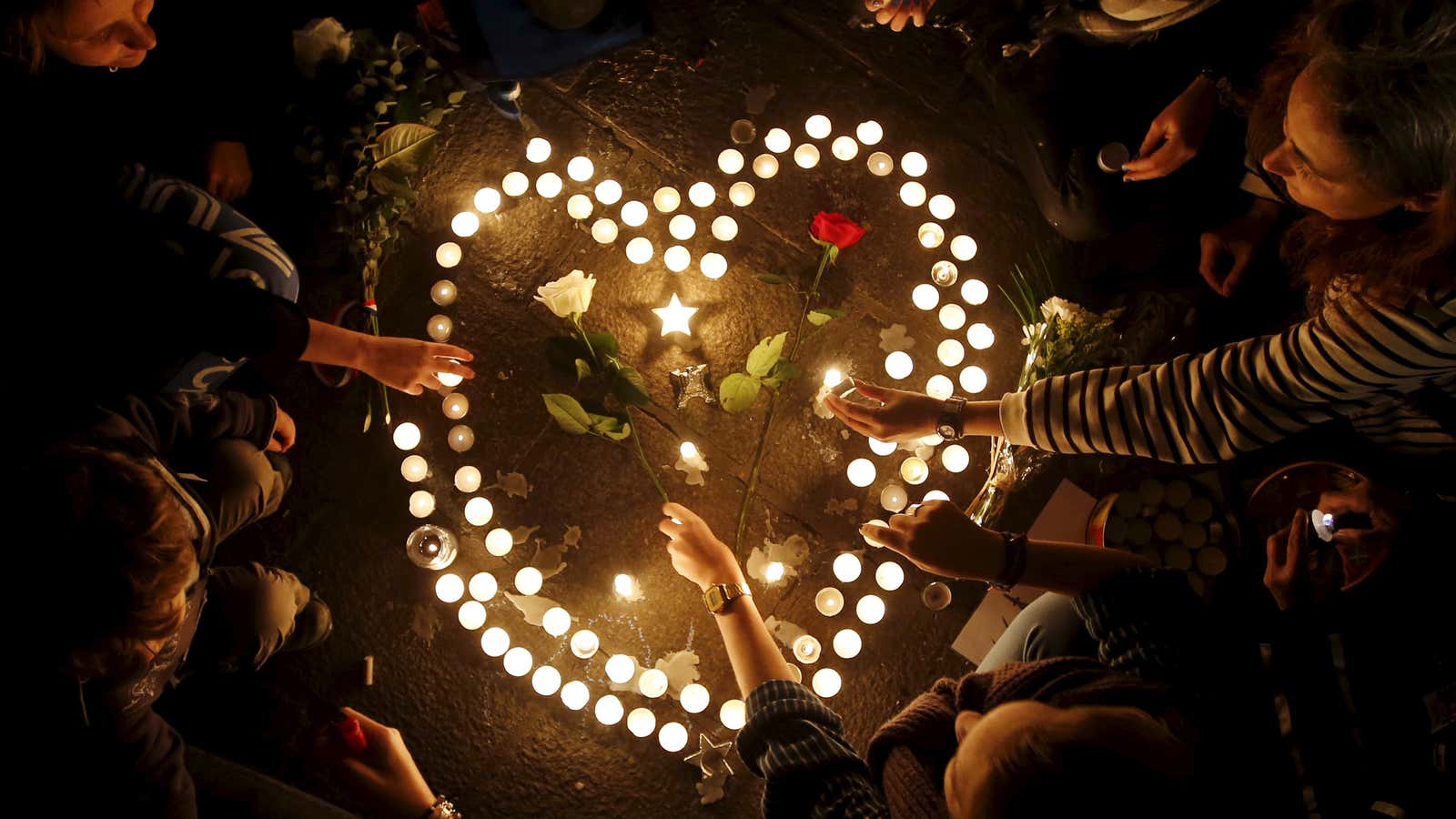 People light candles as they pay tribute to the victims of Friday’s attacks in Paris, at the Old Harbour in Marseille, France, November 14, 2015.