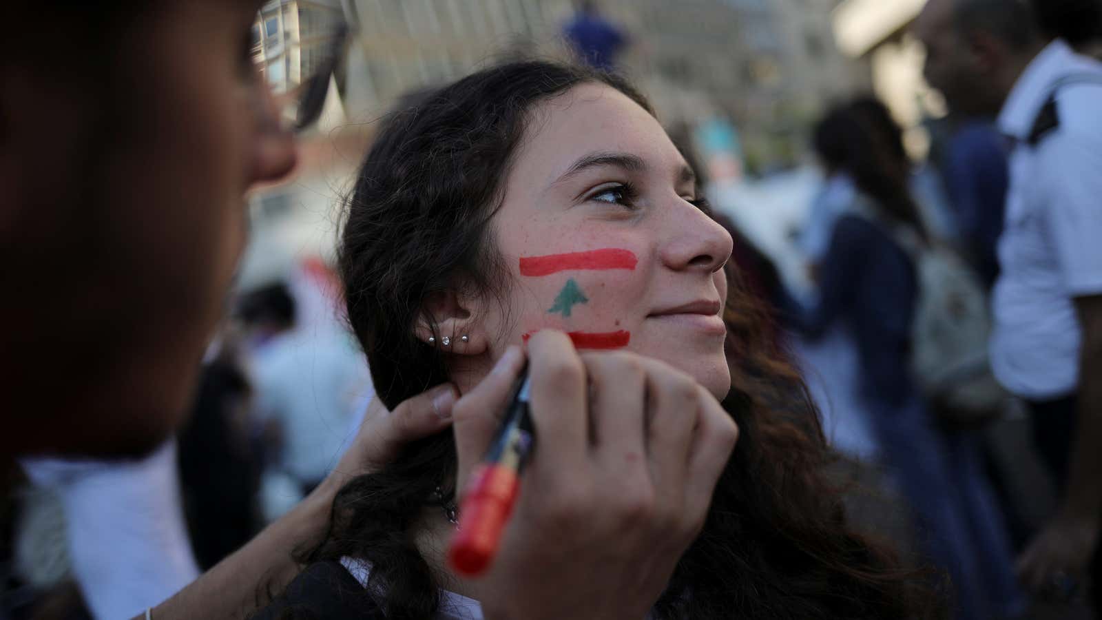 A demonstrator has her face painted.