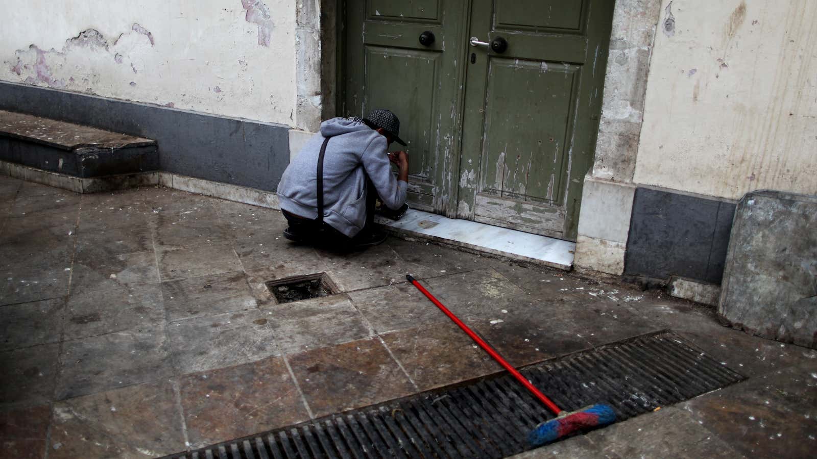 A man eats a meal from a soup kitchen in Athens, on Oct. 17, designated International Day for the Eradication of Poverty.