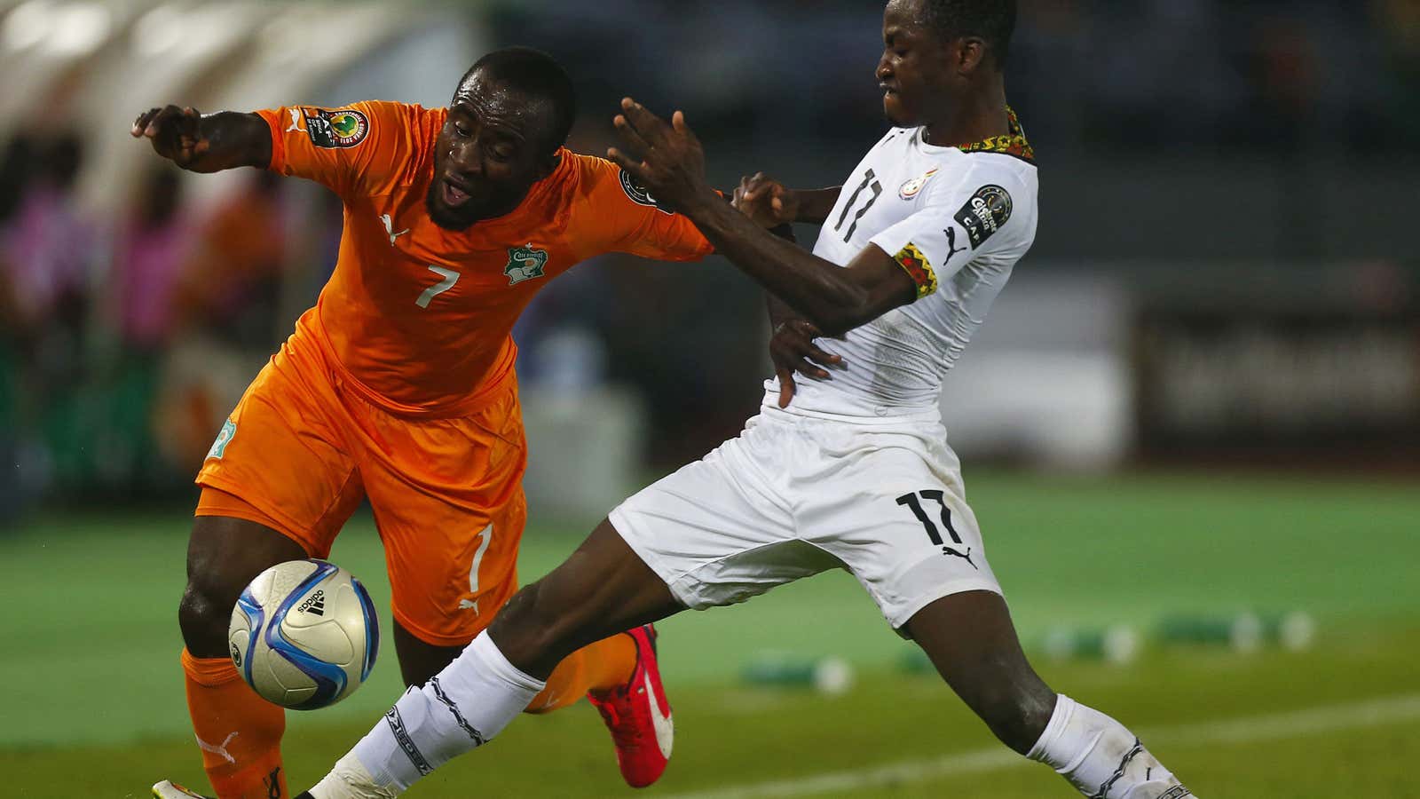 Ivory Coast’s Seydou Doumbia (L) challenges Ghana’s Baba Rahman during the African Nations Cup final on Feb. 8, 2015.