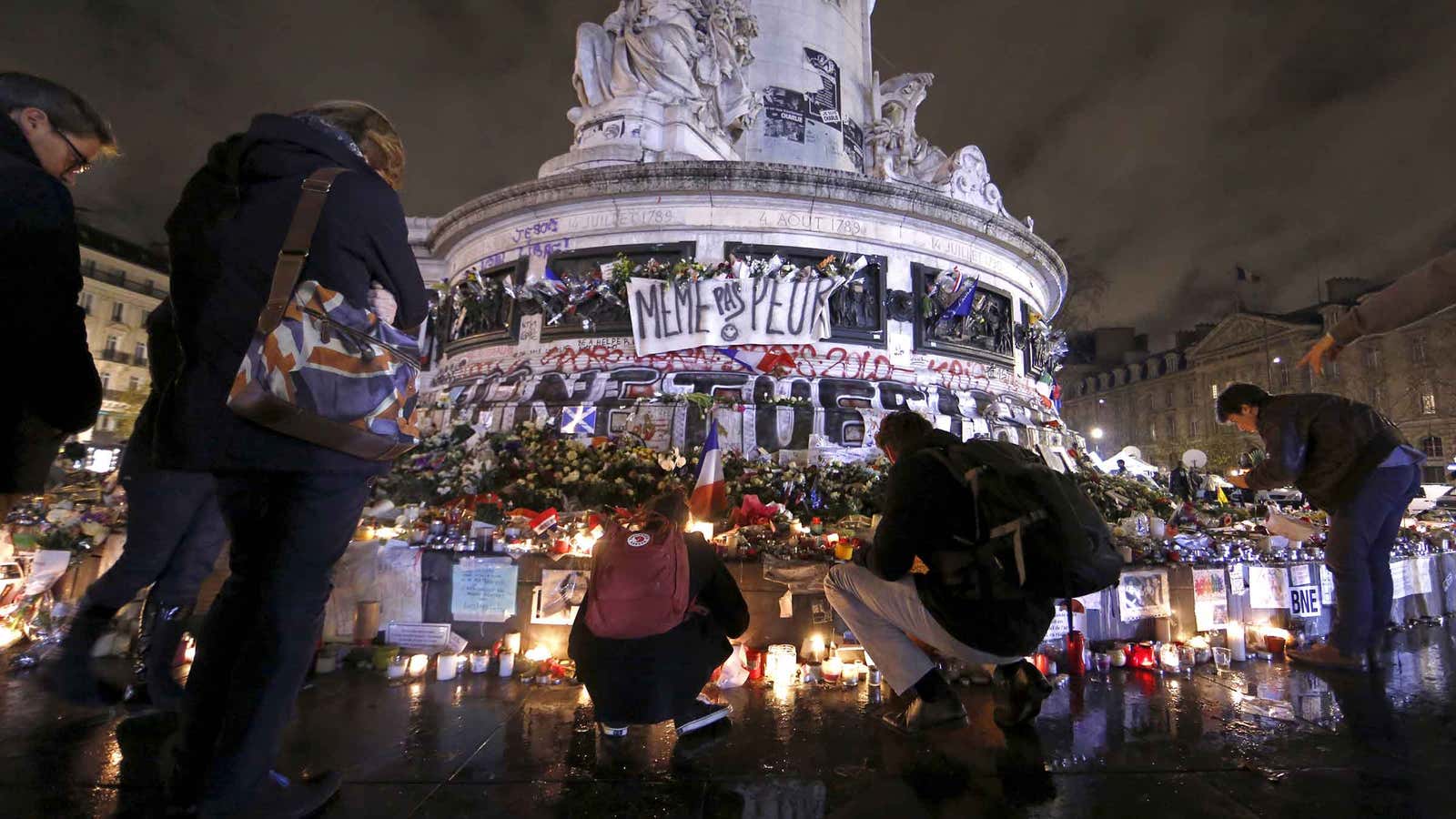 People pay tribute to victims at the Place de la Republique in Paris.