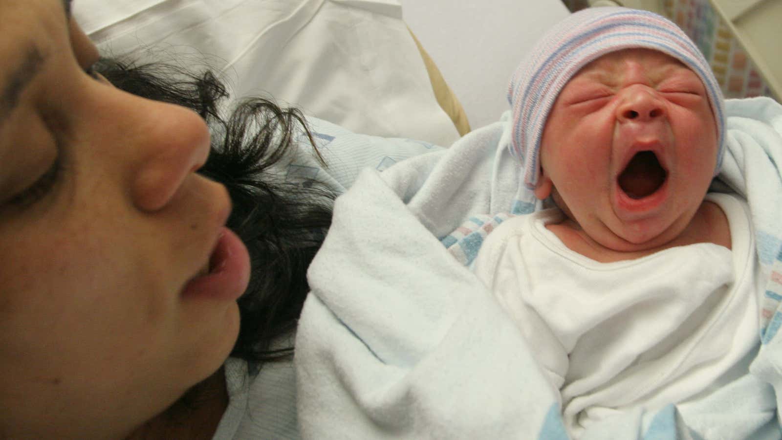 Maria Iozia, of the Queens borough of New York, holds her son Dio Anthony Flores, who was born earlier in the day, as she poses…