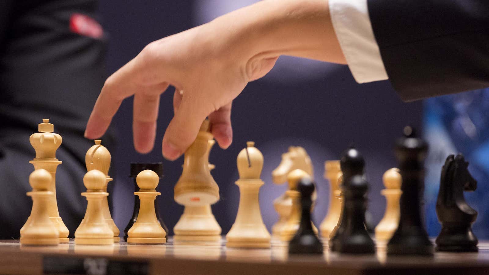 Sergey Karjakin, of Russia, reaches in to take a white piece from his opponent, Magnus Carlsen, of Norway, in Game 12 of the World Chess…