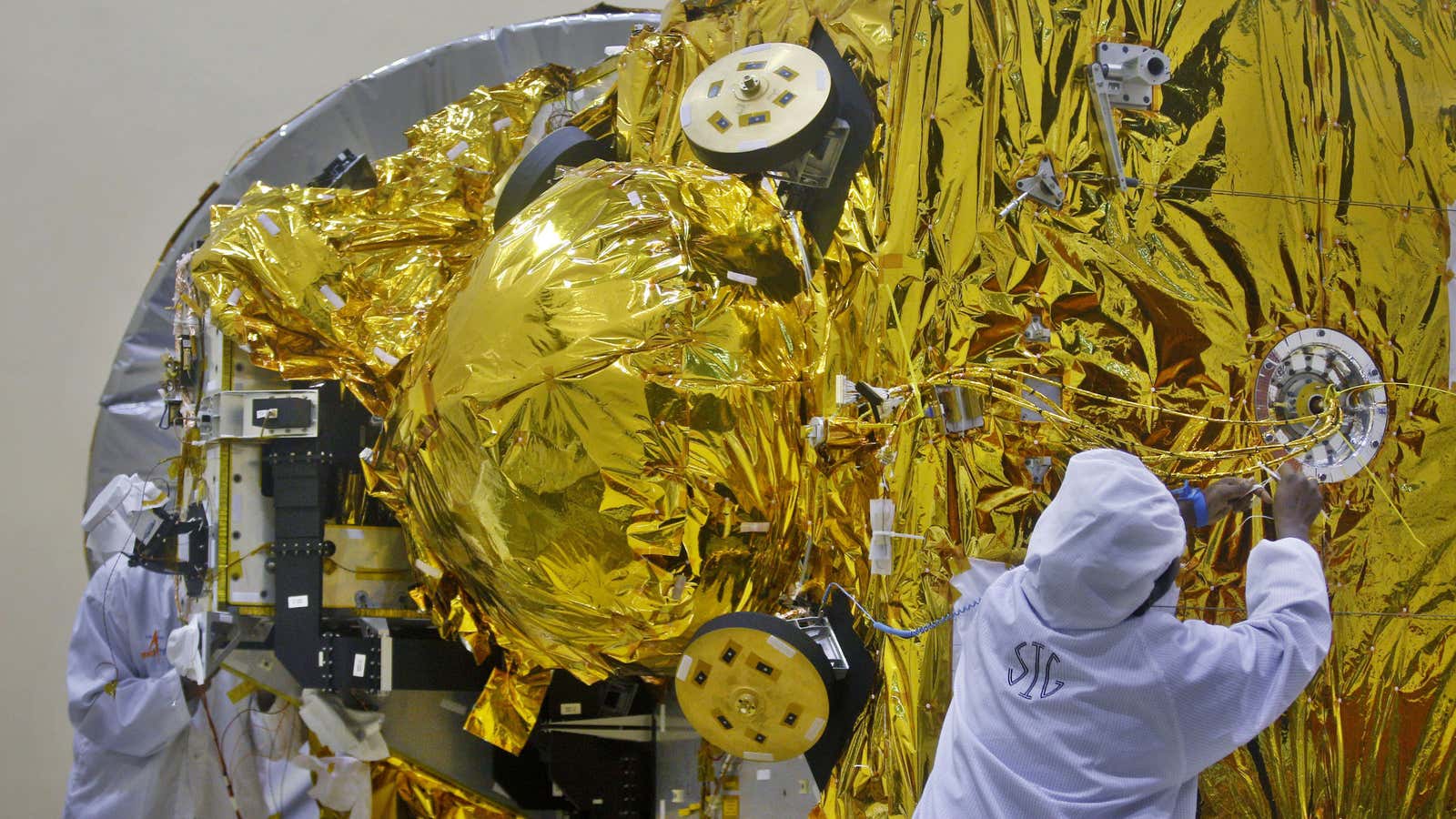 Engineers tinkering with the Mars orbiter spacecraft.