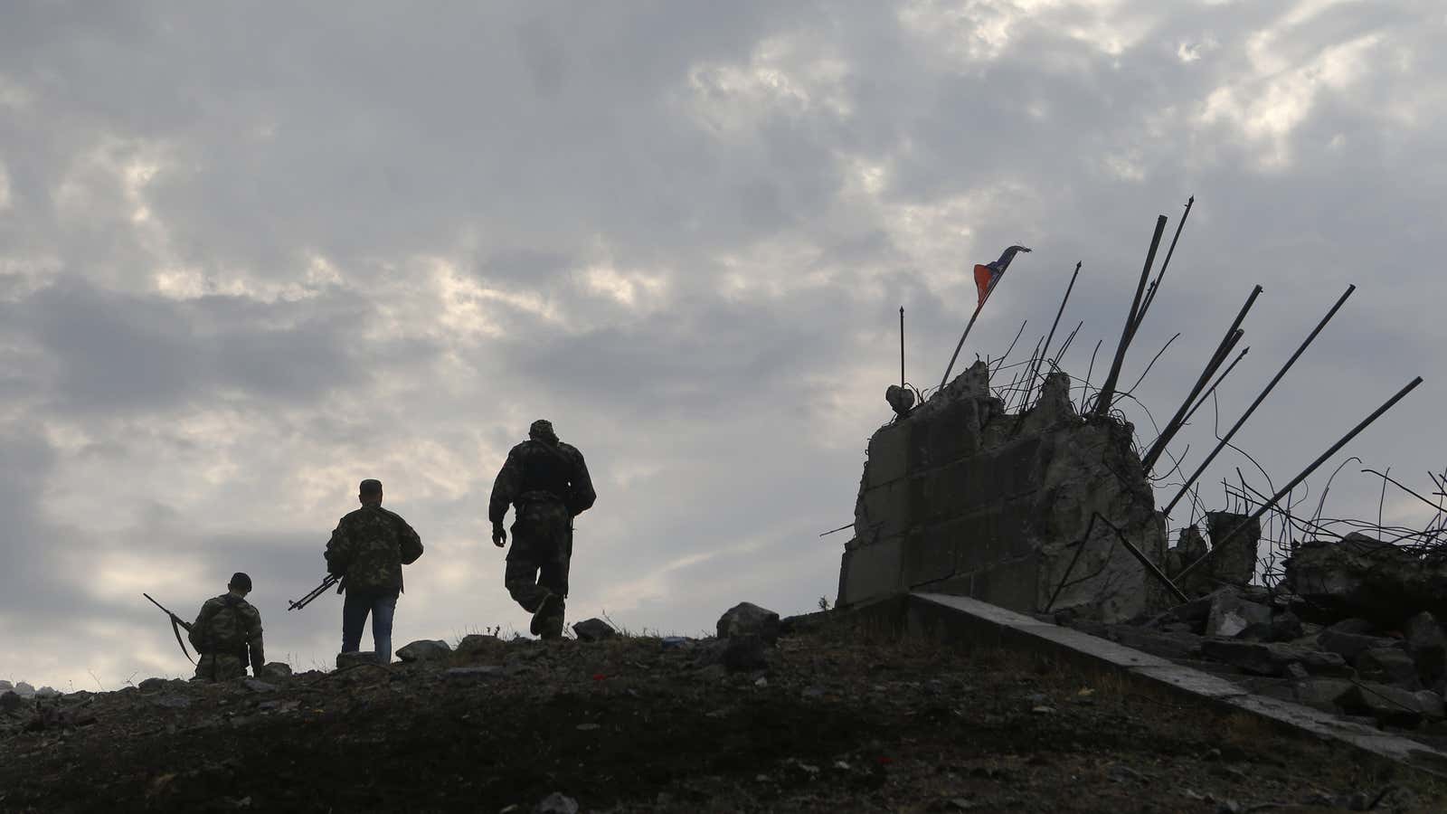 Pro-Russian separatists at a destroyed war memorial east of the city of Donetsk.