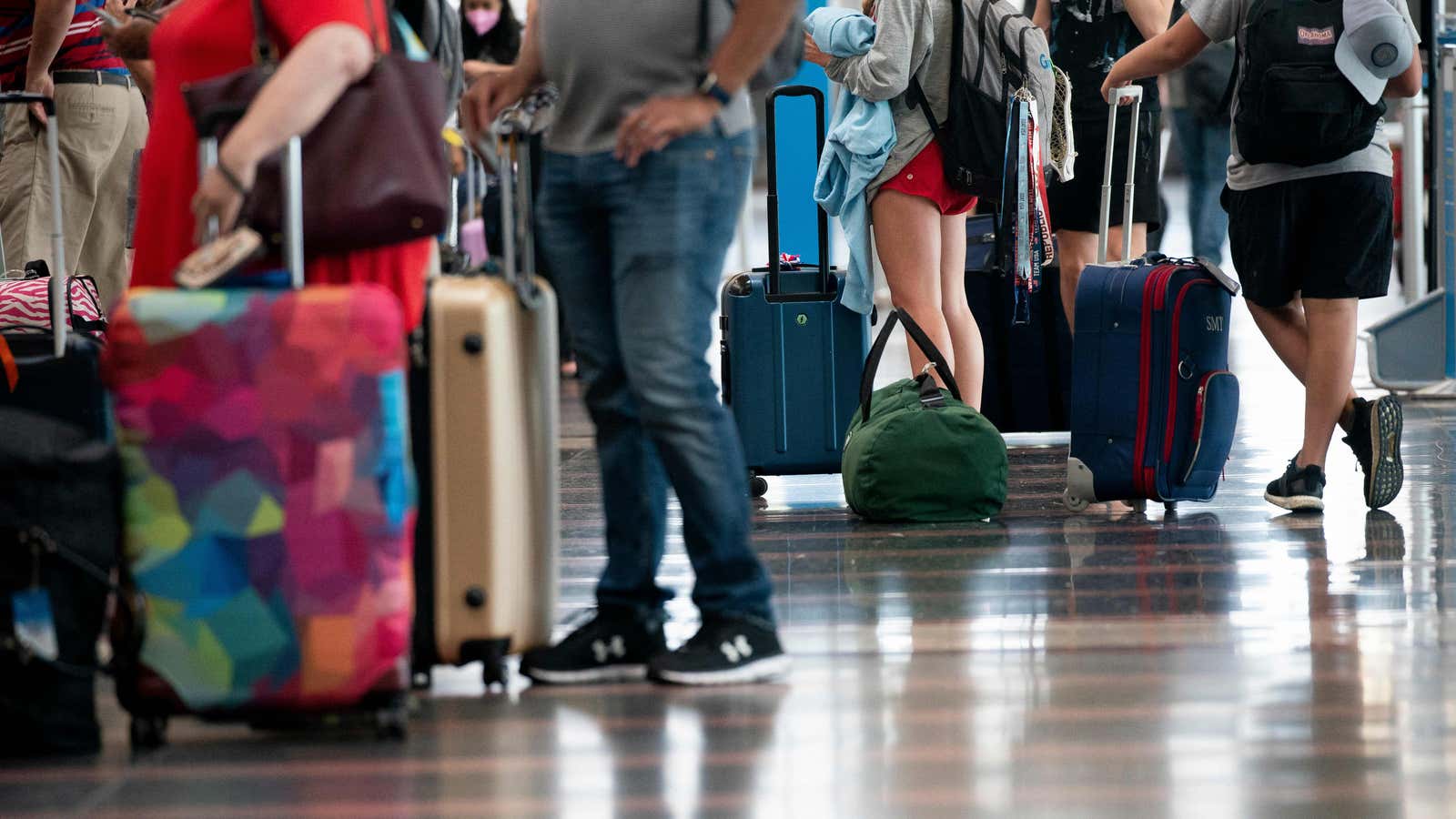 Travelers walk through Ronald Reagan Washington National Airport in Arlington, Virginia, on July 2, 2022.