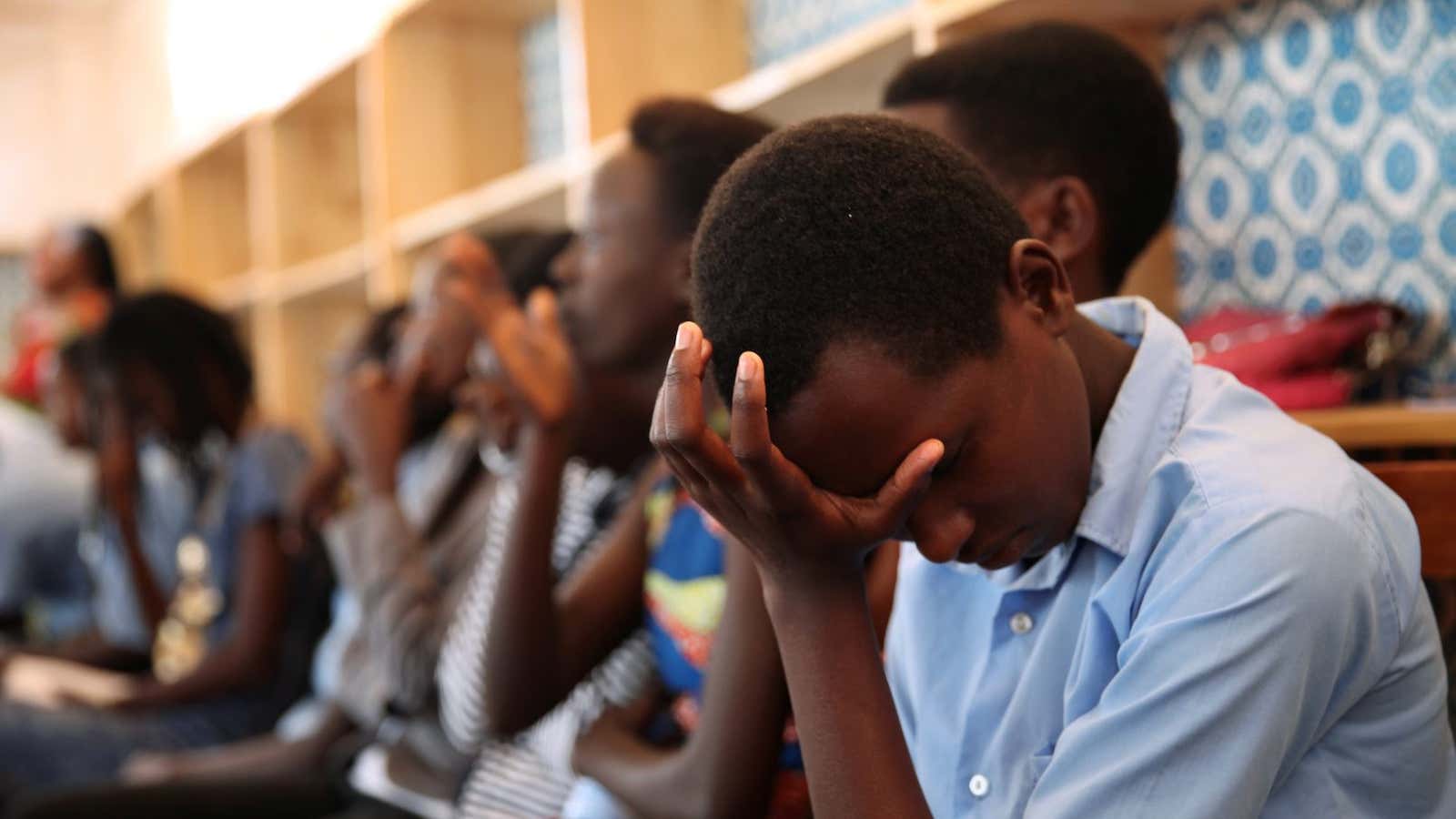 Burundian school girls listen to a talk at a refugee camp in Rwanda.