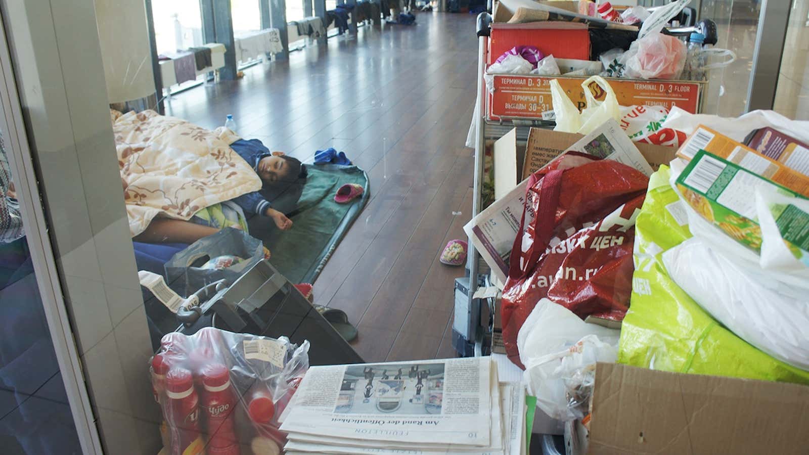 Two of the Ando children nap on an air mattress set up in a former smoking lounge at Moscow’s Sheremetyevo International Airport.