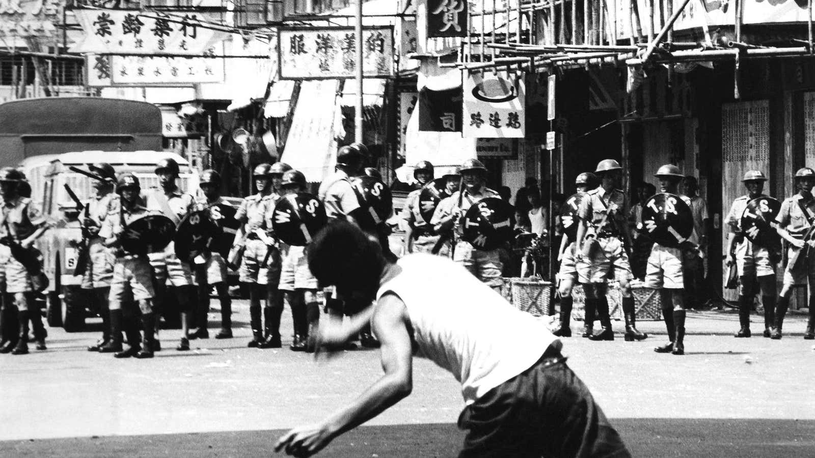 A man hurled rock at a police patrol in Hong Kong in May 1967.