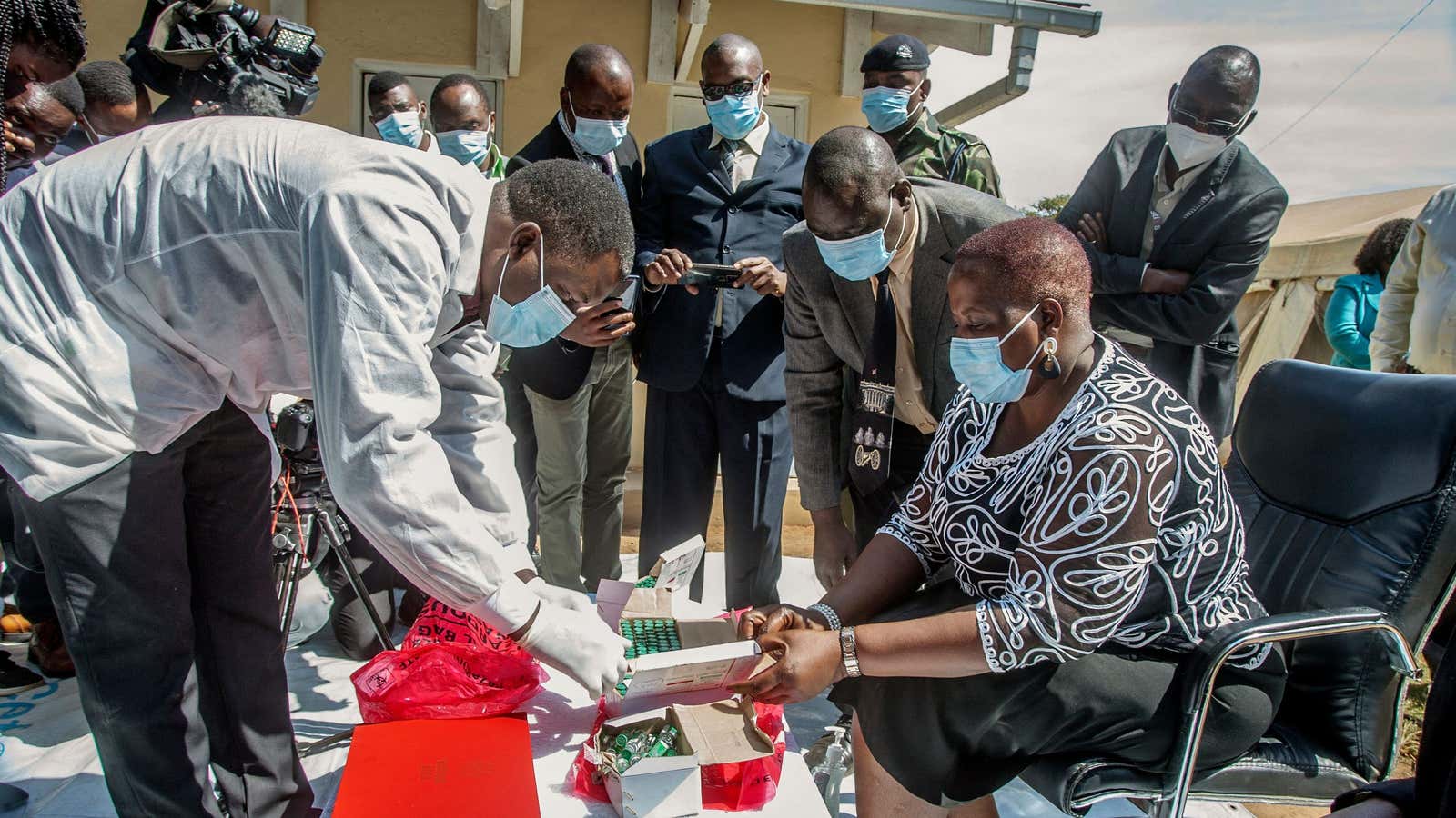 Malawi’s health minister Khumbize Kandodo Chiponda examines vaccines before they are destroyed in Lilongwe on May 19. Malawi has destroyed nearly 17,000 doses of the AstraZeneca vaccine that had expired in mid-April, with the health minister blaming “propaganda” for many Malawians’ reluctance to receive the jab.