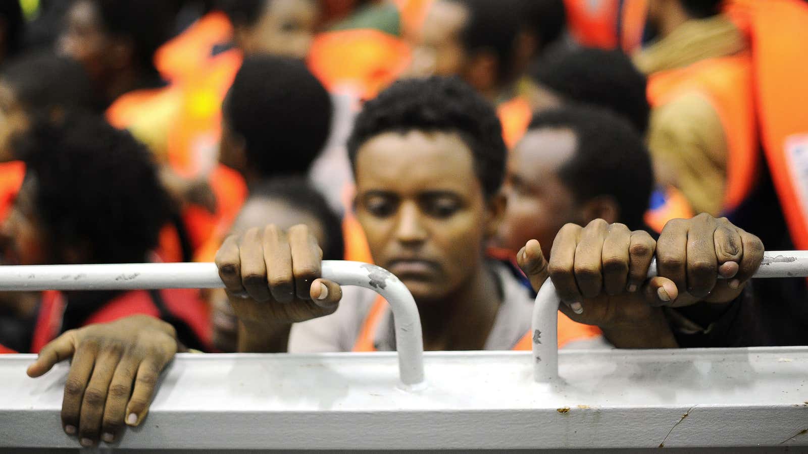 Migrants stand on a landing craft of Italy’s navy ship San Giorgio after being rescued in open international waters in the Mediterranean Sea between the Italian and the Libyan coasts in May 2014.