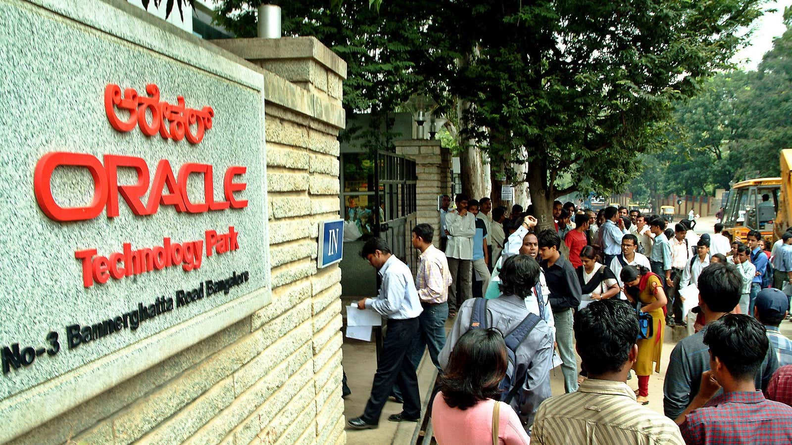 Indian job applicants stand outside an Oracle office in Bangalore.