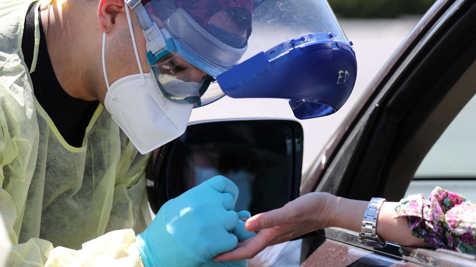 A healthcare worker administers an antibodies test