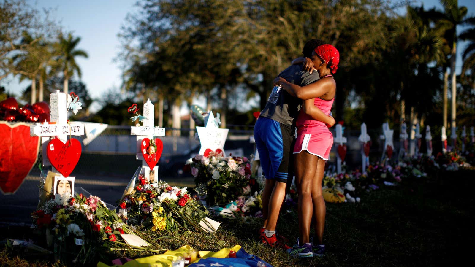 student of the Marjory Stoneman Douglas High School next to crosses to commemorate Parkland, Florida shooting victimes