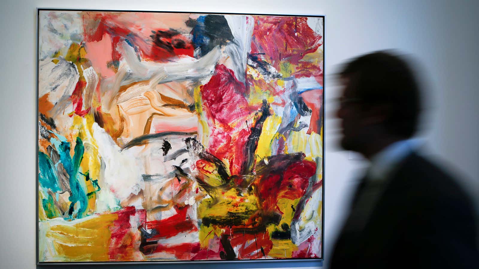 A man walks past “Untitled” by Willem De Kooning