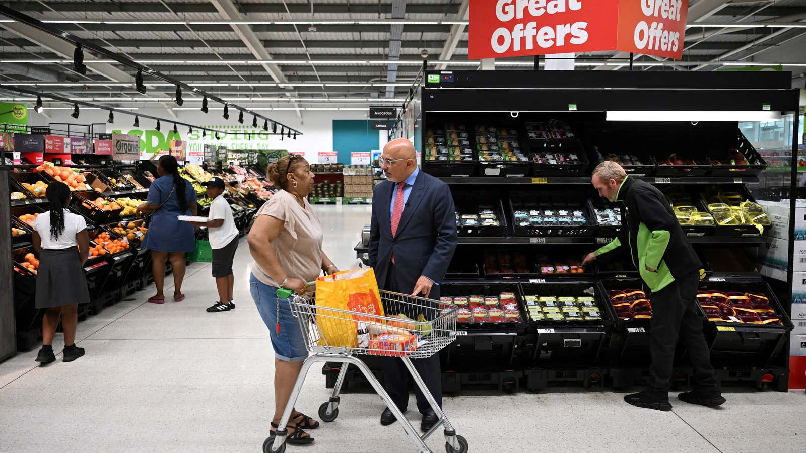 Britain&#39;s Chancellor of the Exchequer Nadhim Zahawi speaks with a customer during a visit of an ASDA supermarket in July 2022 as food prices soar.