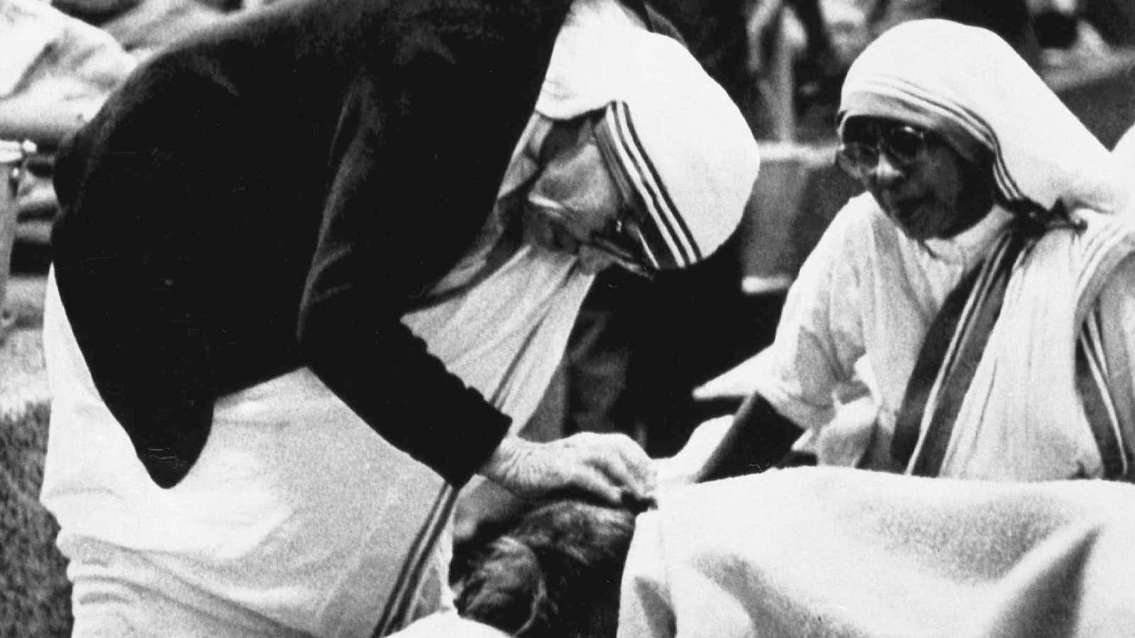 Mother Teresa attends to a patient in her home for the dying in Kolkata in 1986.