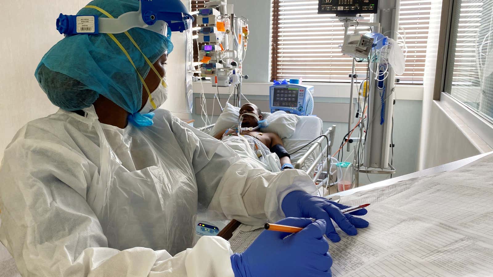 A medical staff attends to a Covid-19 patient in South Africa