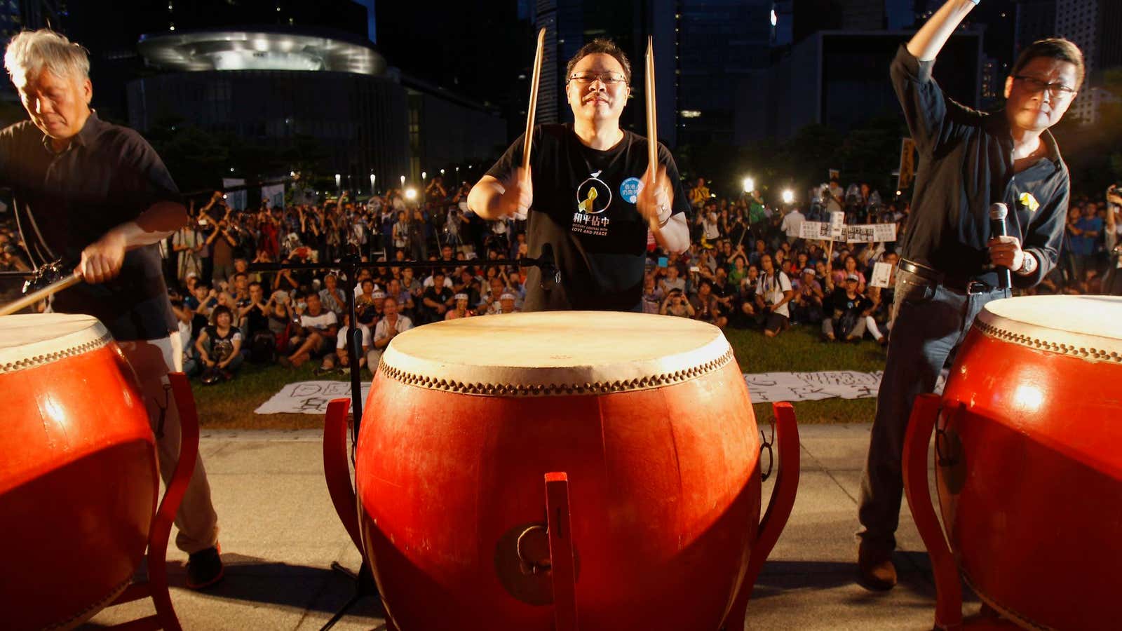 Founders of the Occupy Central civil disobedience movement hit drums during a campaign to kick off the movement in front of the financial Central district in Hong Kong.