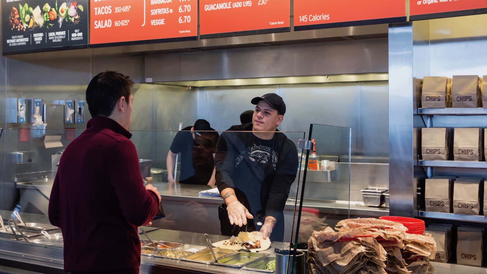 FILE – In this Dec. 15, 2015 file photo, a Chipotle Mexican Grill employee, right, prepares a burrito for a customer in Seattle. An E. Coli outbreak that sickened nearly 50 people resulted in the temporary closure of Chipotle restaurants in Washington and Oregon. The story was a top news item in Washington state in 2015. (AP Photo/Stephen Brashear, File)