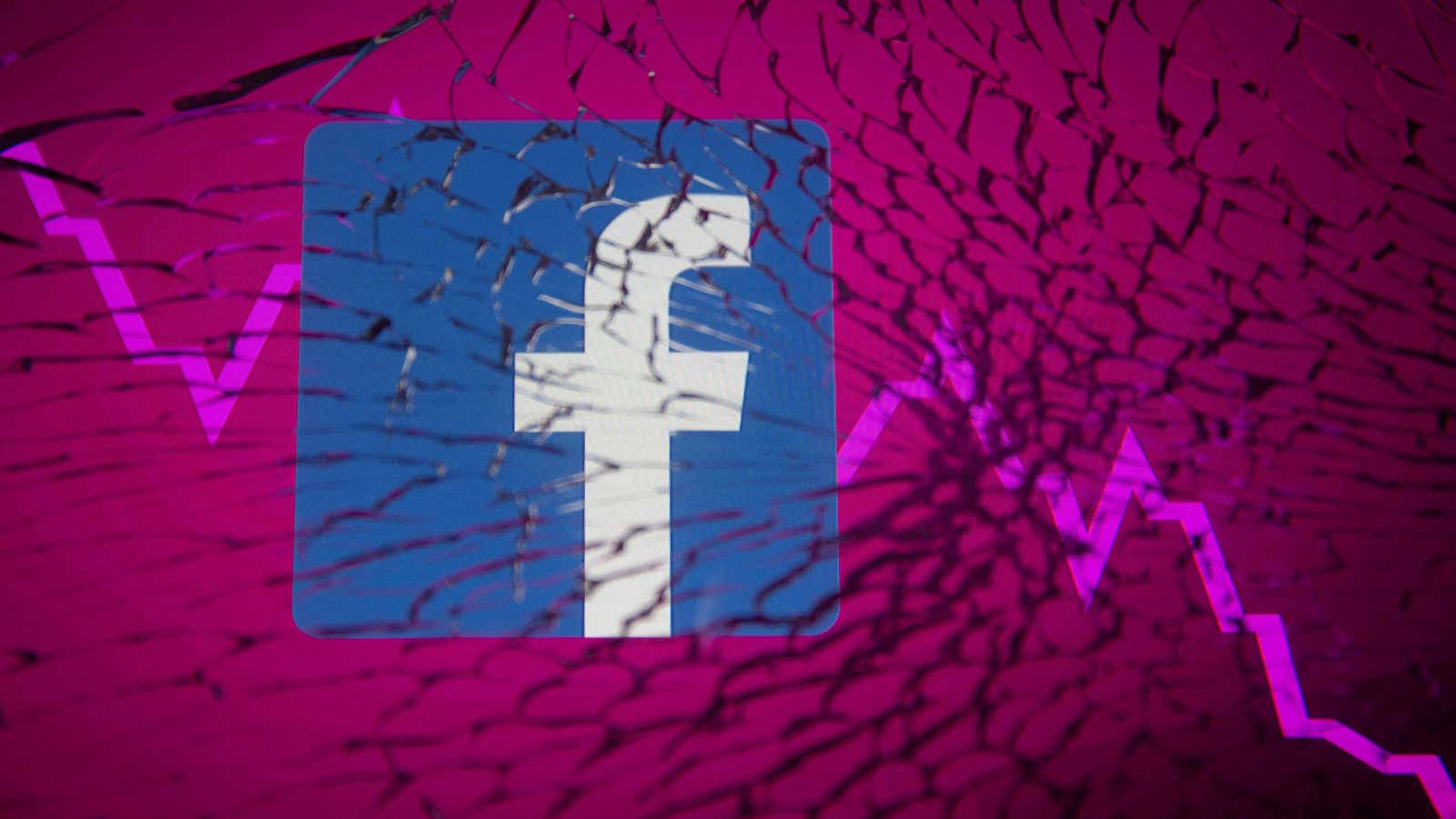 A square Facebook logo and downward trending stock market line are pictured behind a pane of cracked glass.