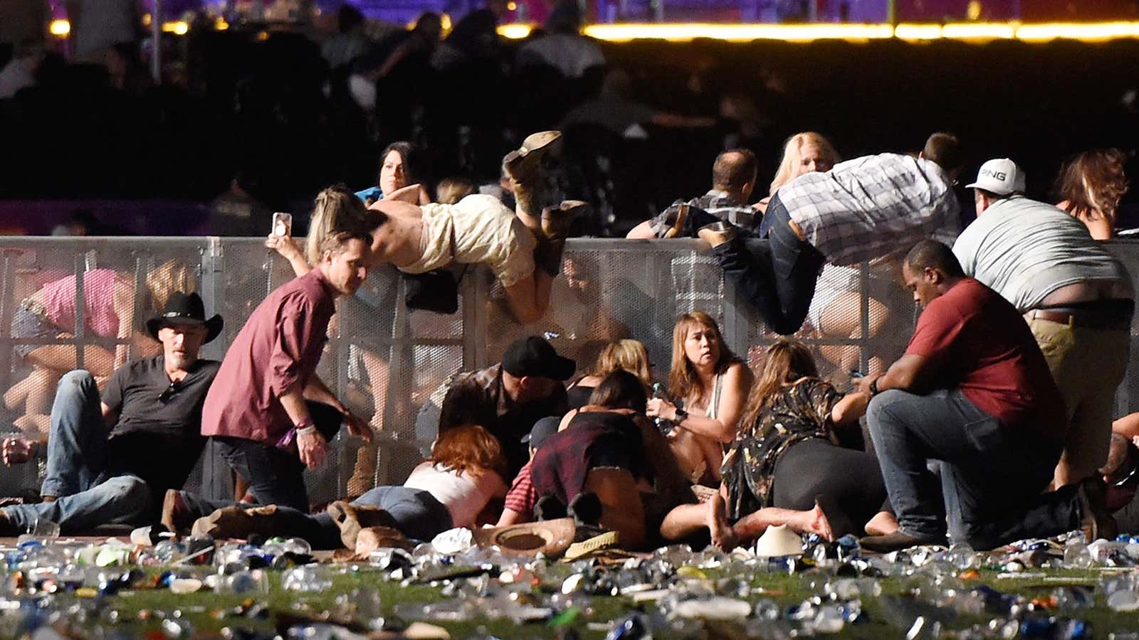 People scramble for shelter at the Route 91 Harvest country music festival.