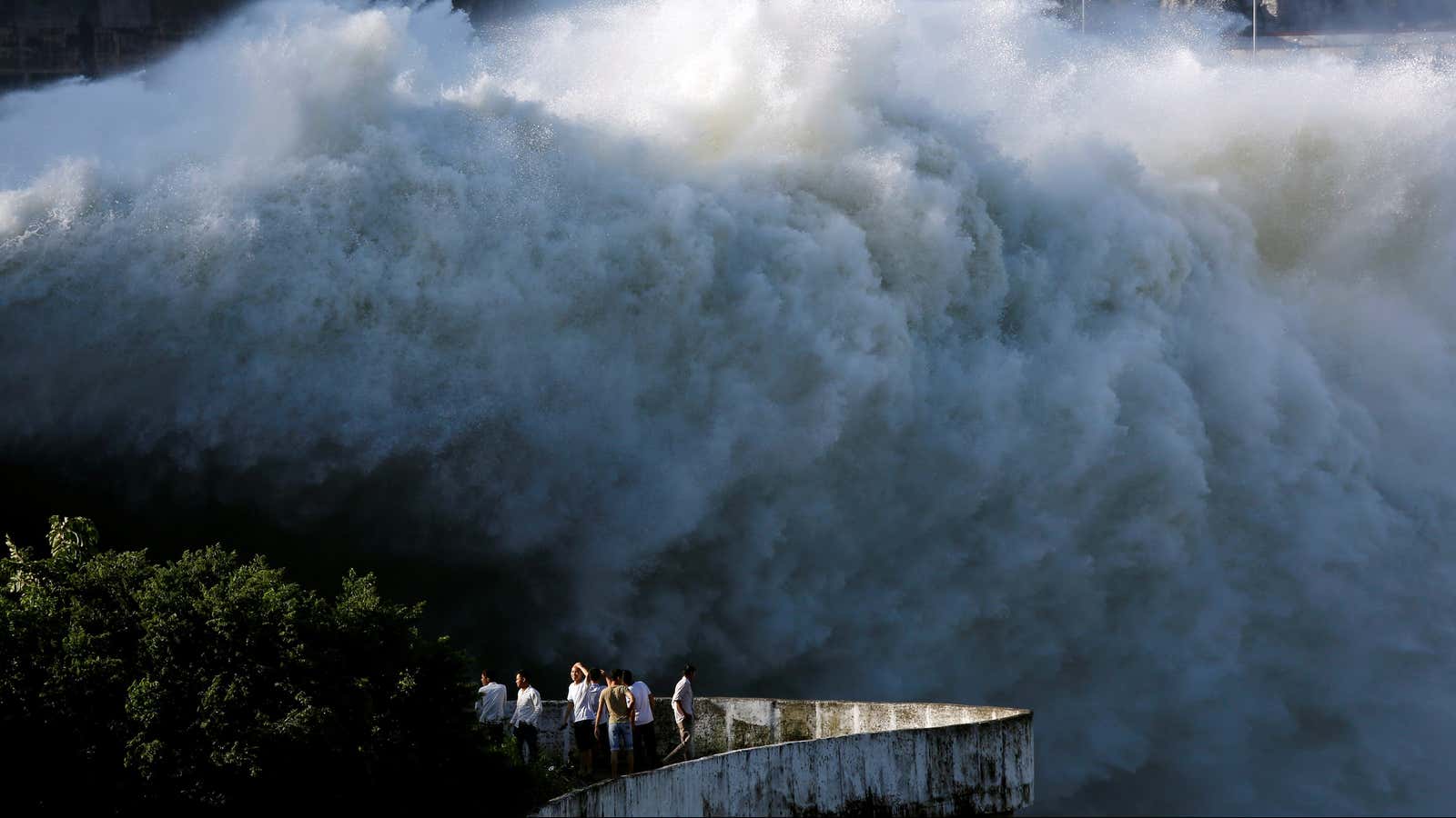 People watch as Hoa Binh hydroelectric power plant opens the flood gates.