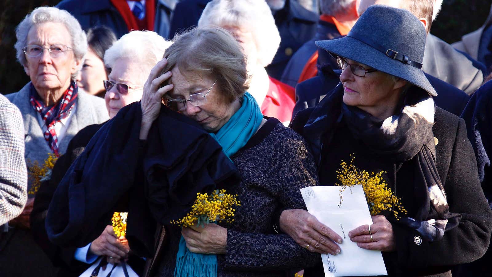 Relatives of the Australian victims of Malaysia Airlines jet MH17 attend a service for the unveiling of a memorial outside Parliament House in Canberra, Australia, Friday, July 17, 2015.