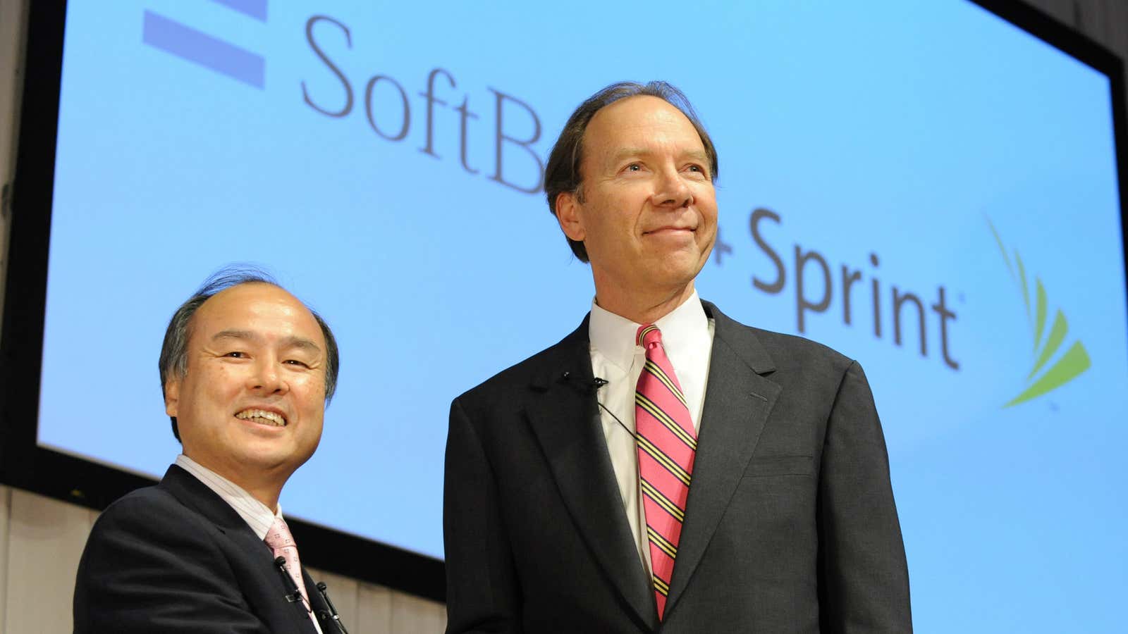 SoftBank and Sprint Nextel bosses Son Masayoshi and Dan Hesse shake on the deal.