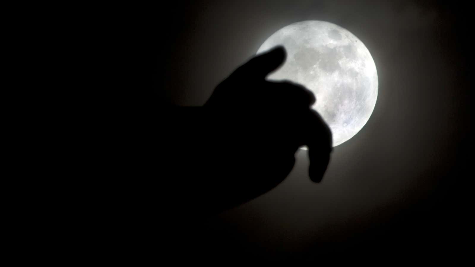 Rising over the hand of a statue in Cairo, Egypt.