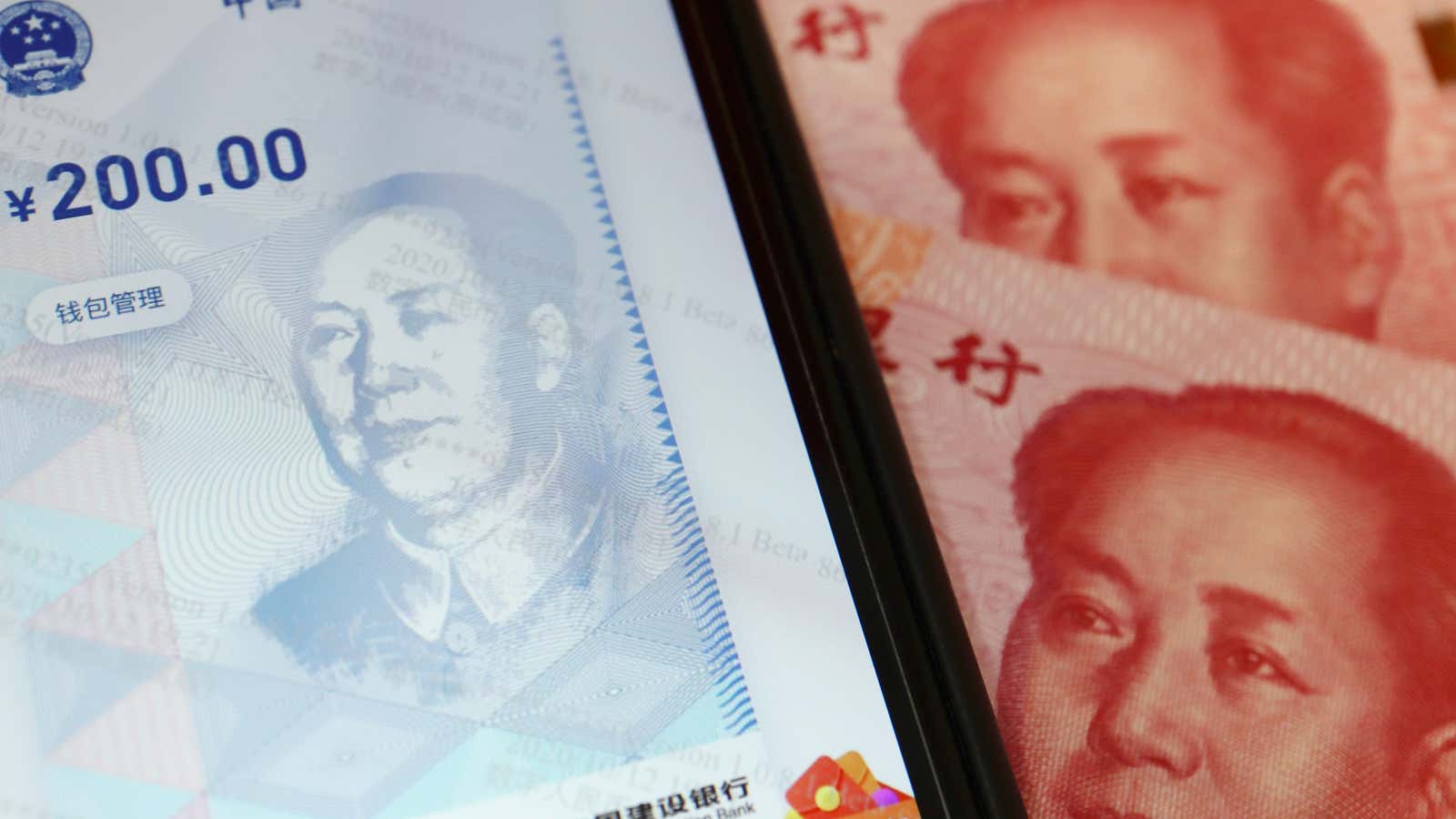 China’s official app for digital yuan is seen on a mobile phone next to 100-yuan banknotes in this illustration picture taken October 16, 2020. REUTERS/Florence…