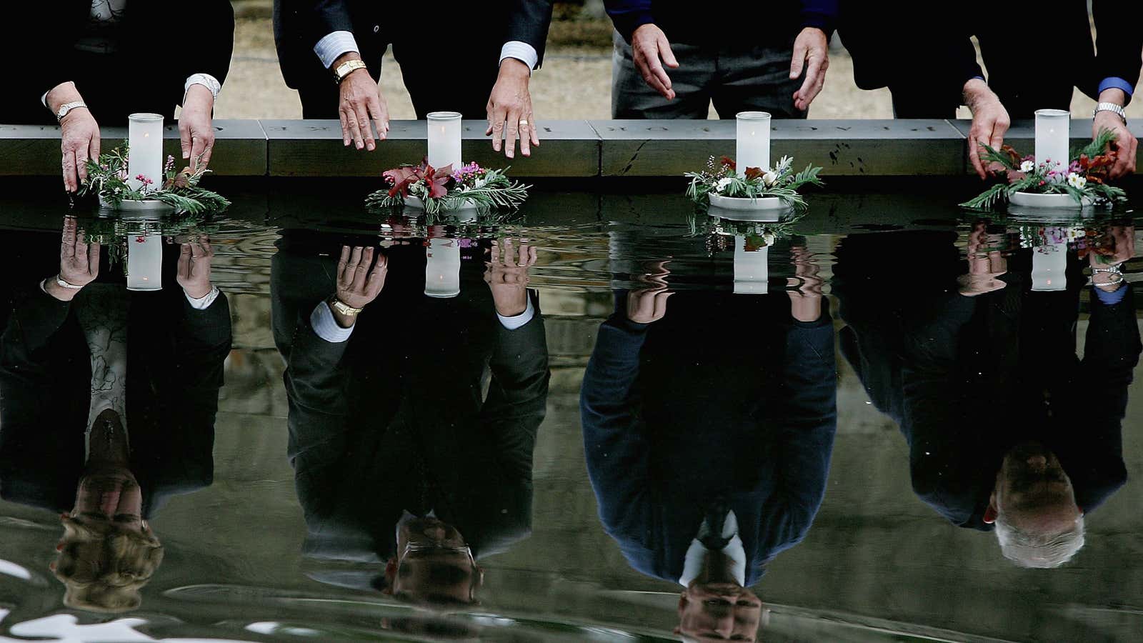 Family and friends lay floating candles to mark the 10th anniversary of the Port Arthur massacre, which killed 35 people.