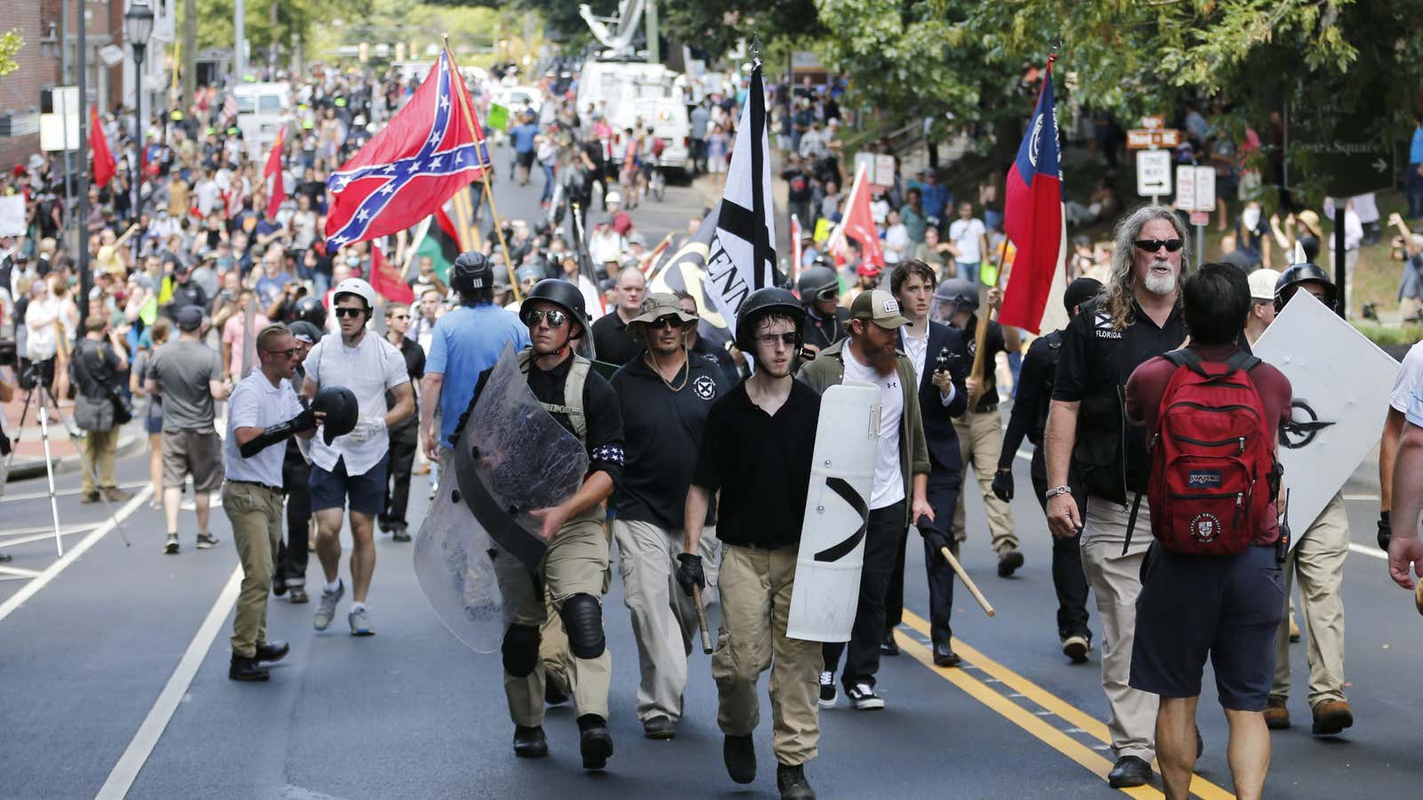 White nationalist demonstrators walk through town after their rally was declared illegal near Lee Park in Charlottesville, Va., Saturday, Aug. 12, 2017.