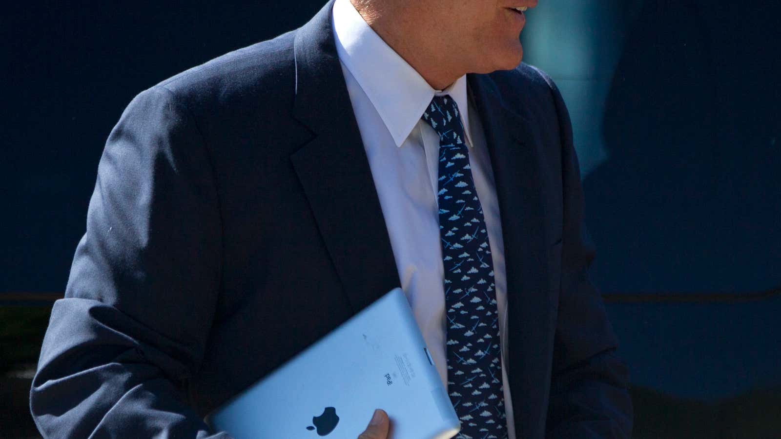 Mitt Romney carrying an iPad into the Church of Jesus Christ of Latter-day Saints