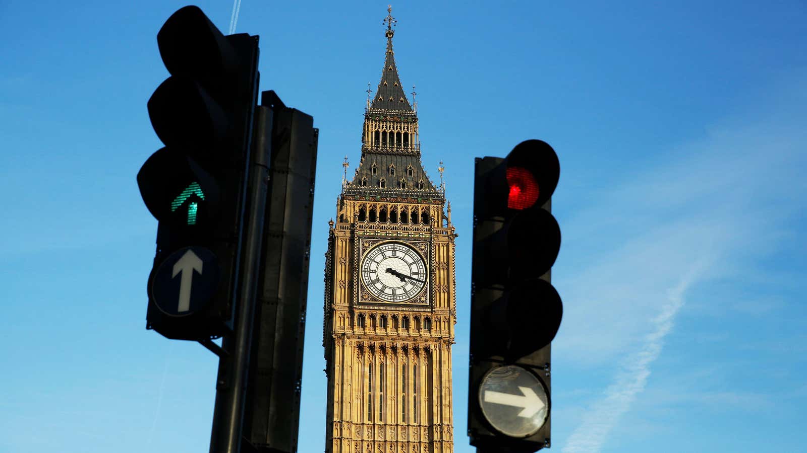 Red and green traffic lights direct traffic in front of the Big Ben bell tower at the Houses of Parliament in London, Britain February 22,…