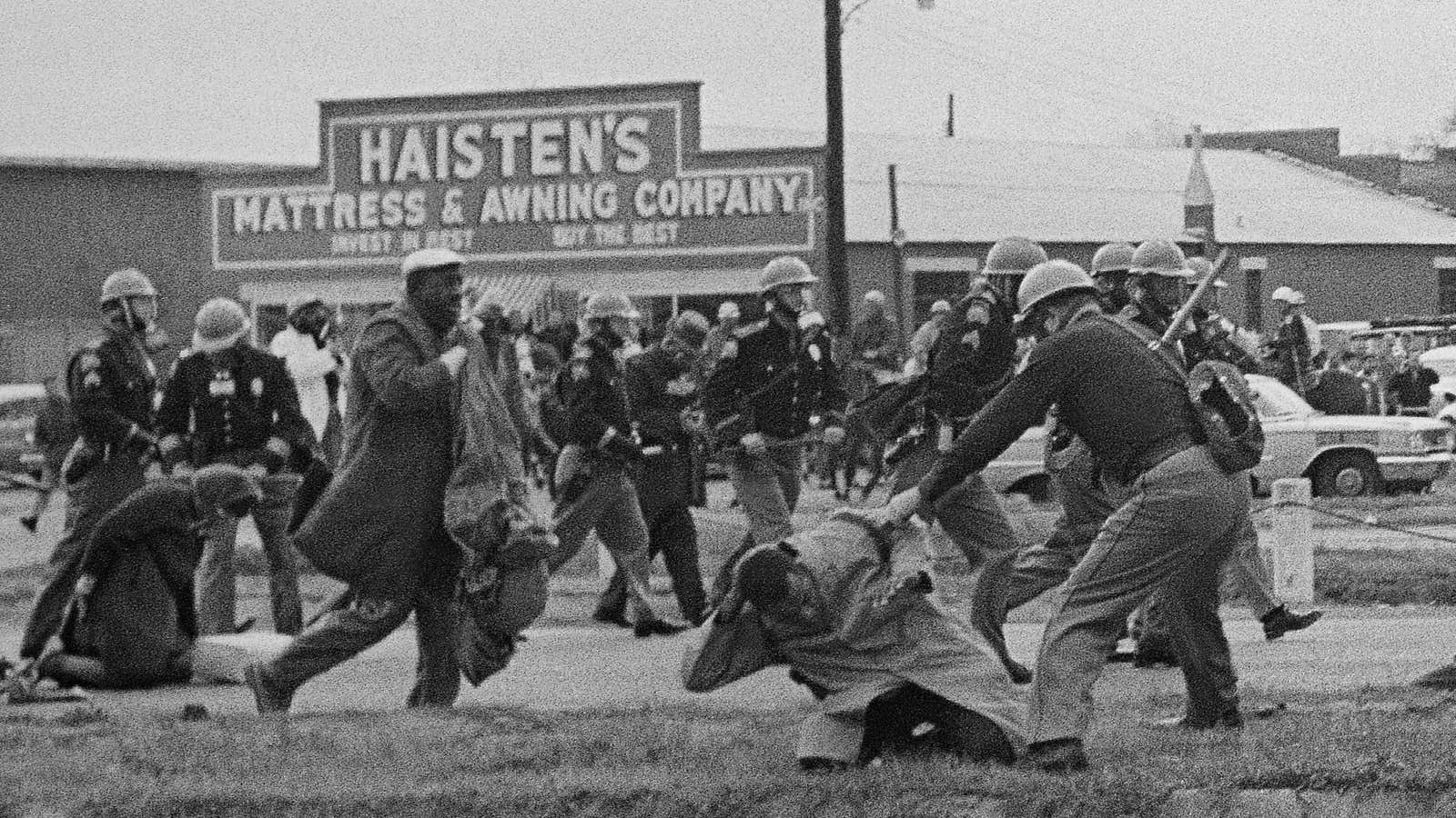 Lewis, chairman of the Student Nonviolent Coordinating Committee is being beaten by a state trooper in Selma, Alabama.