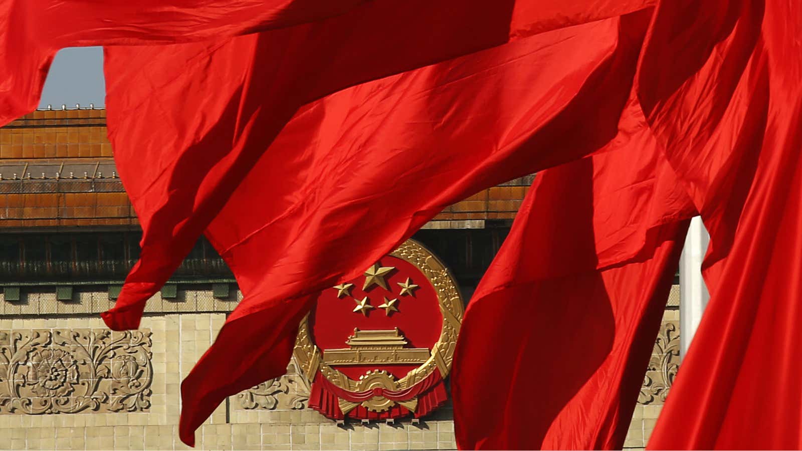 Flags in front of The Great Hall of the People, where the plenum was held.