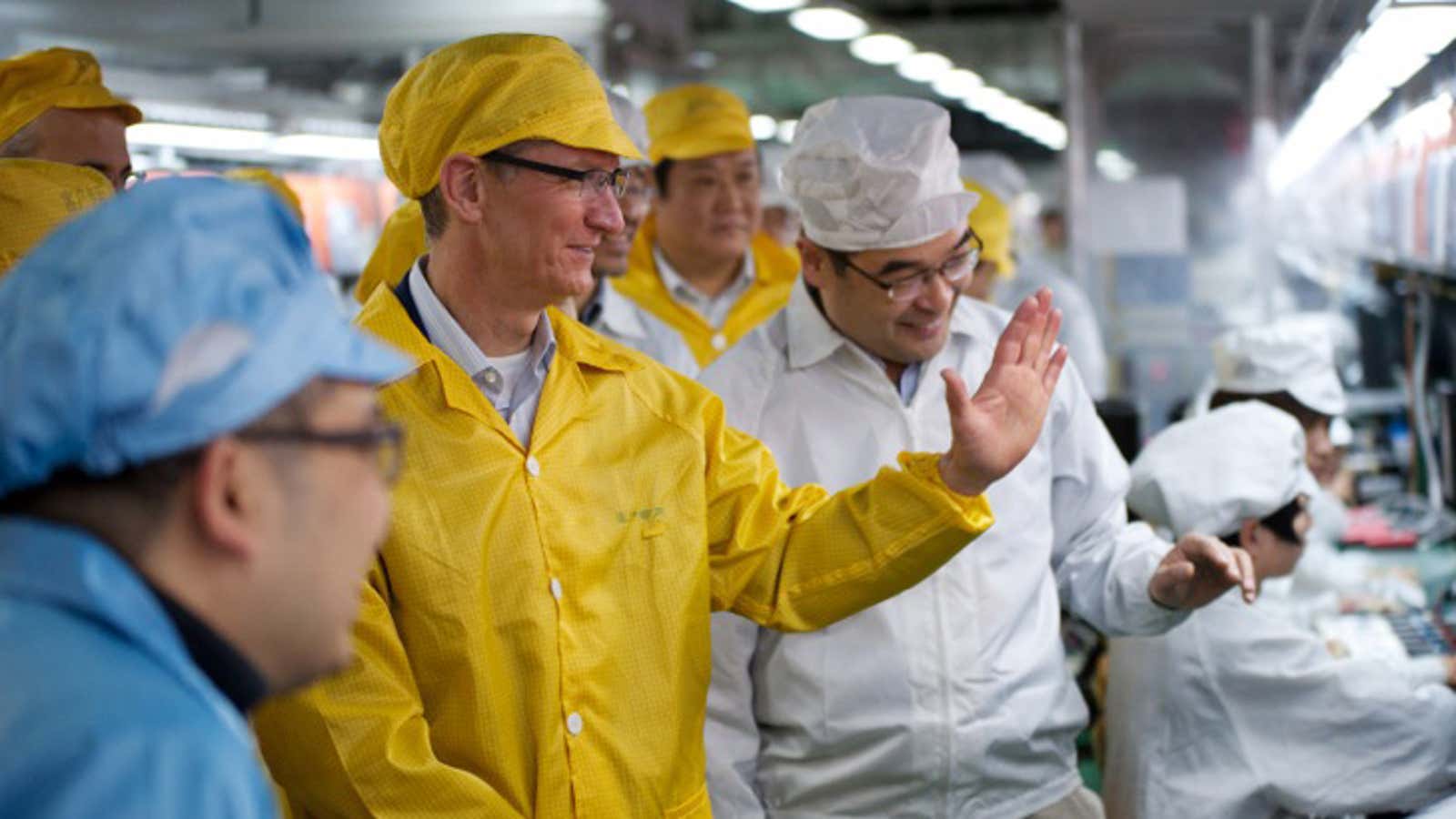 The offshoring winner’s circle: Highly-skilled American workers like Apple CEO Tim Cook and low-skilled Chinese workers, like these FoxConn employees.