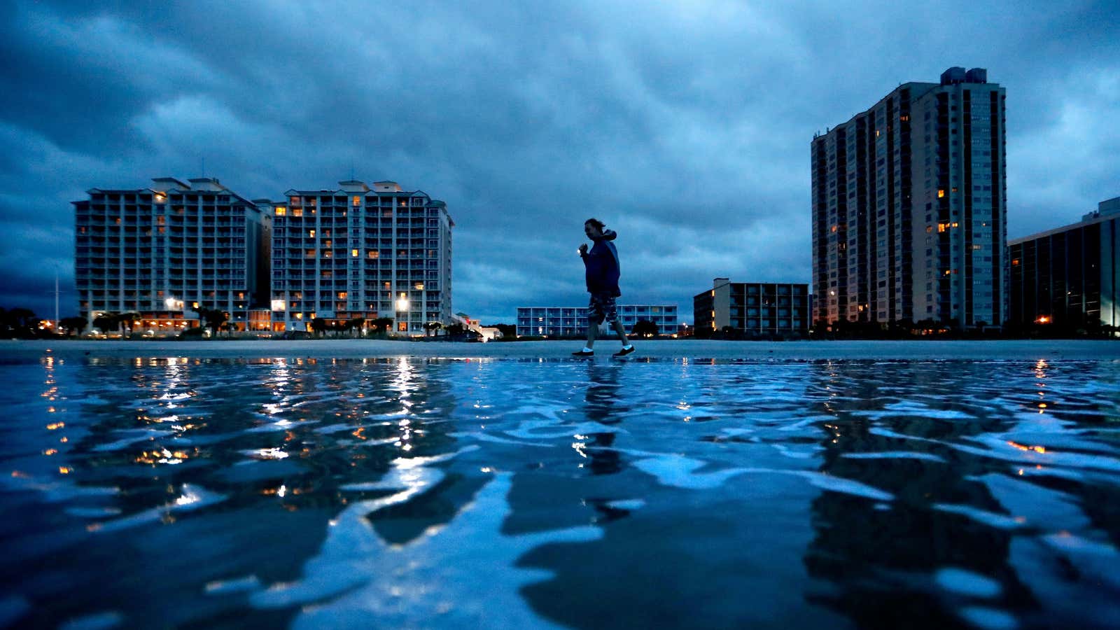 Russ Lewis looks for shells along the beach as Hurricane Florence approaches Myrtle Beach, S.C., Friday, Sept. 14, 2018. “We might get lucky we might…