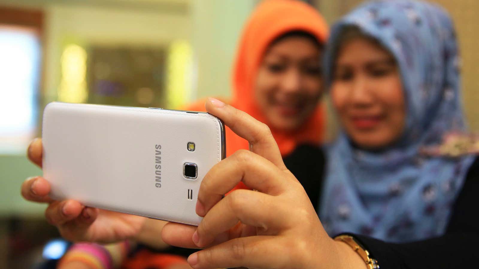 Women in Jakarta pose for a photo.