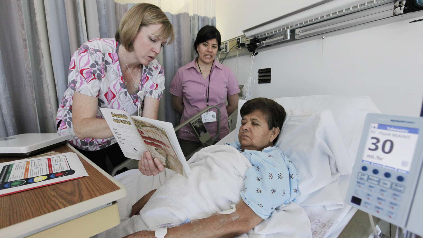 In this Aug. 25, 2011 photo, registered nurse Mary Schlitter, left, speaks to heart patient Maria Marure, with the help of medical interpreter Marina Moreno…