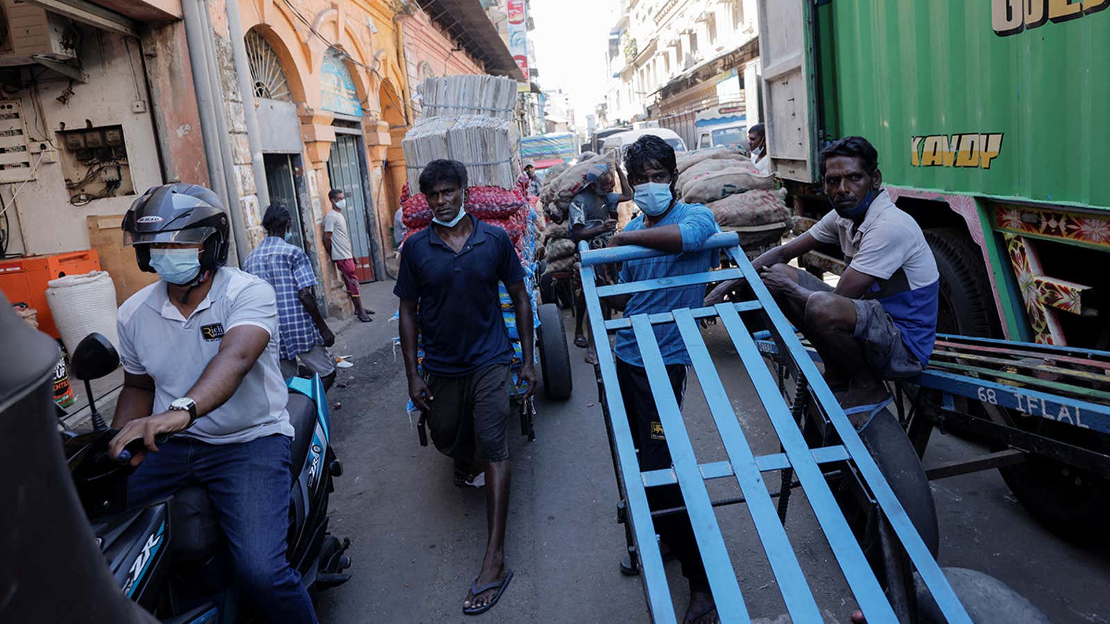 FILE PHOTO: Men wait with their carts at a market, amid the country’s economic crisis in Colombo, Sri Lanka, April 7, 2022. REUTERS/Dinuka Liyanawatte/File Photo