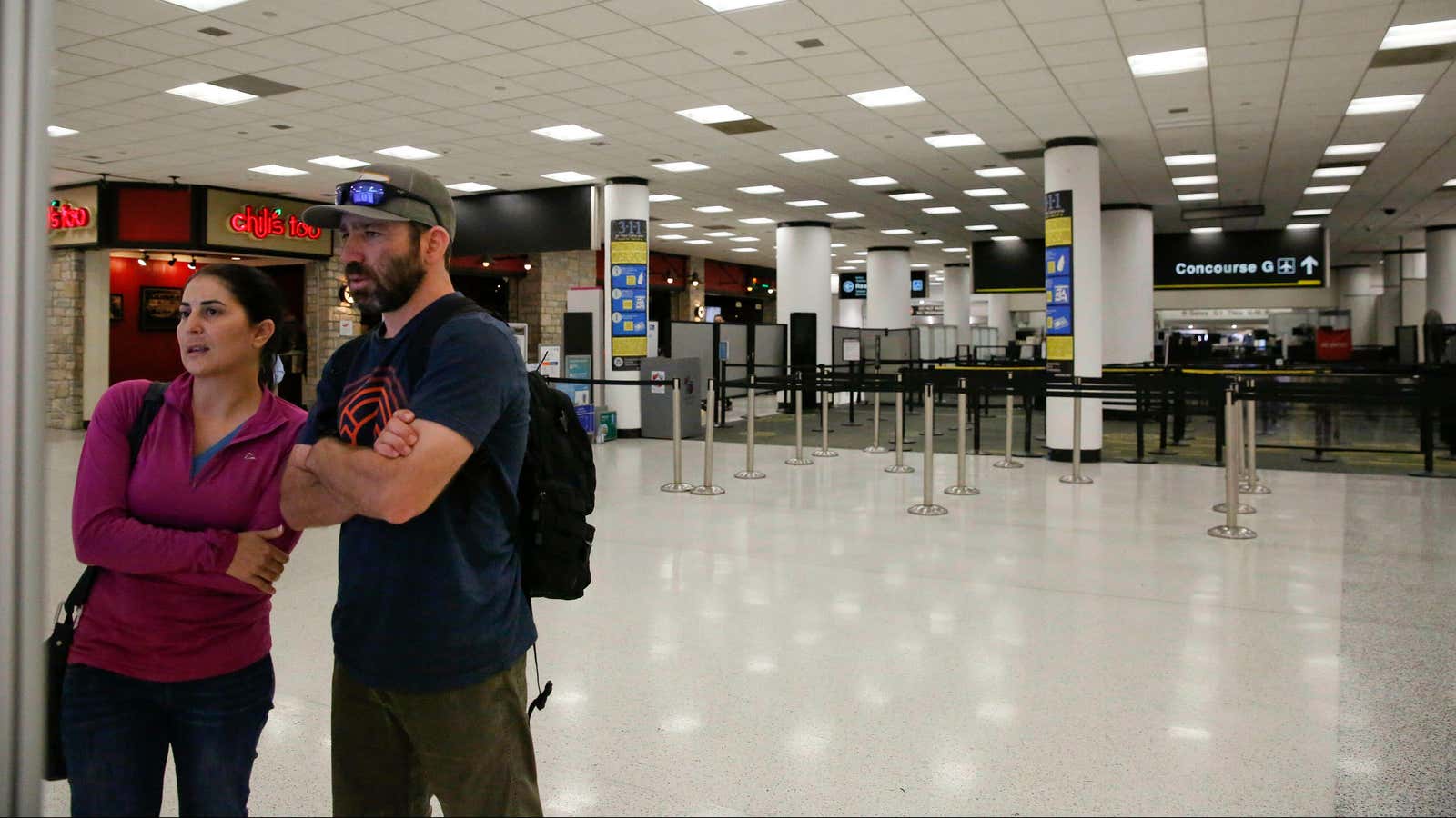 Travelers trying to find their concourse at Miami International Airport.