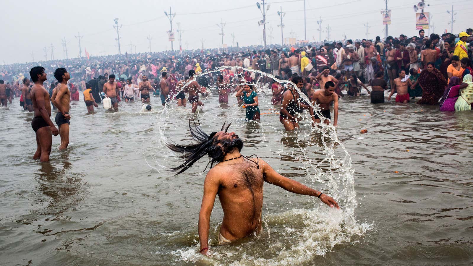 Hindu devotees bathe in the waters of the holy Ganges river during the start of the Maha Kumbh Mela.