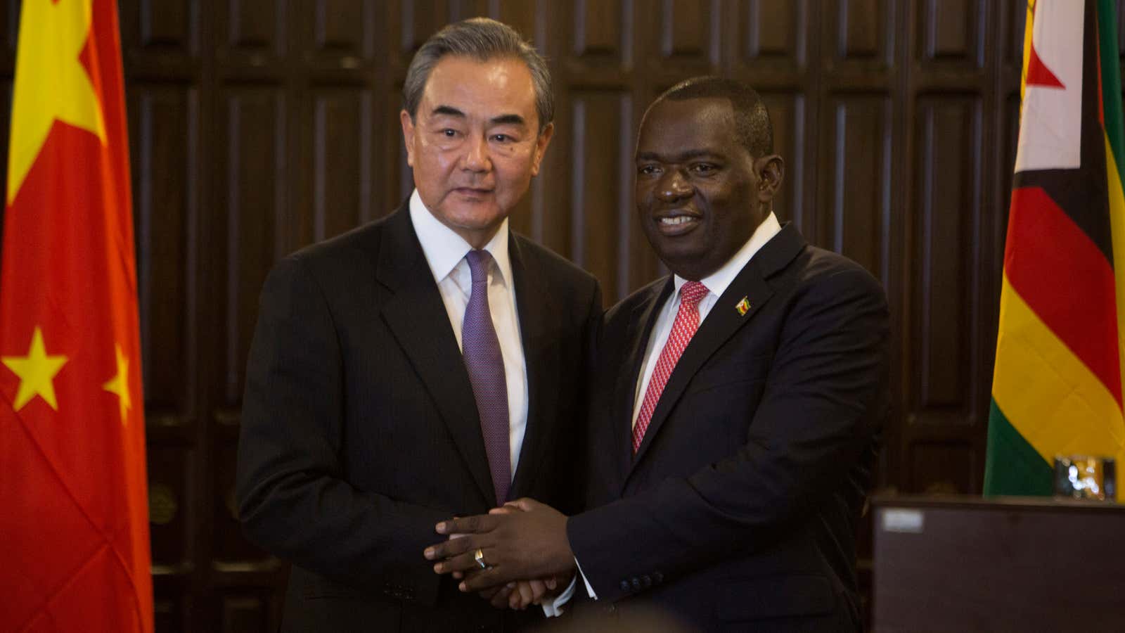 China’s Foreign Minister Wangi Yi, left, greets Zimbabwe’s Foreign Minister Sibusiso Moyo in Harare, Zimbabwe, Sunday, Jan, 12, 2020.